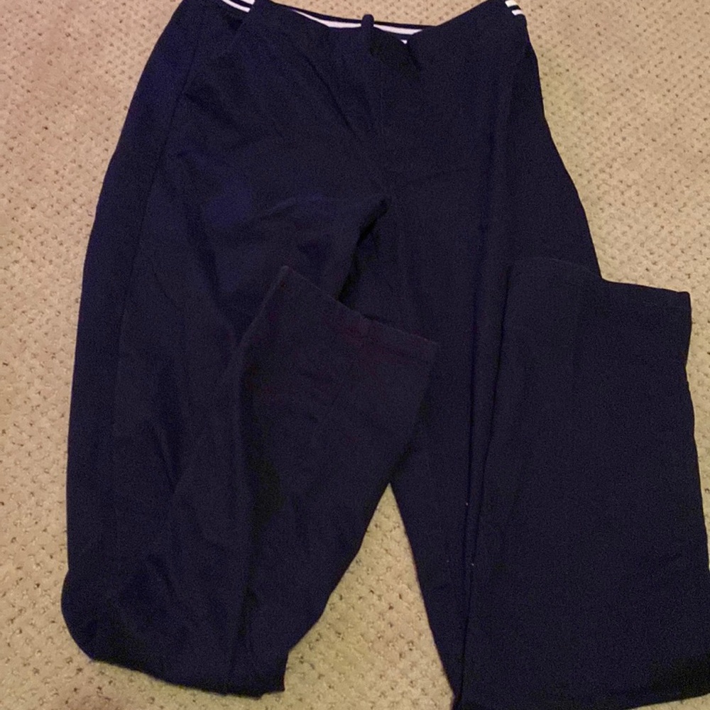 Navy blue khaki pants with stripes going from the sides to the back